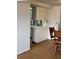 View from dining area into the kitchen with white cabinetry and countertops at 3621 Beacon Square Dr, Holiday, FL 34691