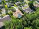 Aerial shot of a well-maintained home featuring a screened pool and mature landscaping at 375 Holly Hill Rd, Oldsmar, FL 34677