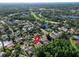 An aerial shot of a house in a green neighborhood, near a lake and golf course at 375 Holly Hill Rd, Oldsmar, FL 34677