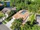 Aerial showcasing house with pool, landscaping, and proximity to the lake at 375 Holly Hill Rd, Oldsmar, FL 34677