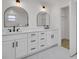 Elegant bathroom featuring double sinks, modern fixtures, and a walk-in closet at 375 Holly Hill Rd, Oldsmar, FL 34677