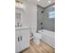 Bathroom features updated vanity, bronze fixtures, and a shower and tub with blue tile at 375 Holly Hill Rd, Oldsmar, FL 34677
