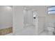 Bright bathroom featuring a stand-up shower, marble flooring, and a modern toilet at 375 Holly Hill Rd, Oldsmar, FL 34677