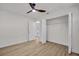 Bedroom with an open closet space, light vinyl floors and an exterior door to the backyard at 375 Holly Hill Rd, Oldsmar, FL 34677