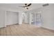 Bedroom features light vinyl floors, a fan and an exterior door to the backyard bar at 375 Holly Hill Rd, Oldsmar, FL 34677