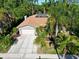 Charming home with lush tropical landscaping, solar panels, and a spacious driveway at 375 Holly Hill Rd, Oldsmar, FL 34677