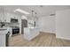 Bright kitchen with white cabinets, stainless steel appliances, and a kitchen island at 375 Holly Hill Rd, Oldsmar, FL 34677