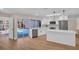 Well-lit kitchen with white countertops, stainless appliances and easy access to the pool area at 375 Holly Hill Rd, Oldsmar, FL 34677