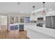 Modern kitchen with white cabinets, stainless appliances, and views of pool at 375 Holly Hill Rd, Oldsmar, FL 34677