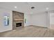 Bright living room featuring a brick fireplace and light wood floors at 375 Holly Hill Rd, Oldsmar, FL 34677