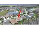 Aerial view of home featuring mature landscaping, pond, and great curb appeal at 4136 Shrewbury Pl, Land O Lakes, FL 34638