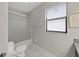 Bathroom featuring a shower/tub, toilet, framed art, and window with blinds at 4136 Shrewbury Pl, Land O Lakes, FL 34638