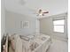 Bedroom featuring a ceiling fan, carpet, window and a queen sized bed at 4136 Shrewbury Pl, Land O Lakes, FL 34638