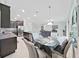 Dining area with a table set for a meal, connecting the kitchen with stainless appliances and the living area at 4136 Shrewbury Pl, Land O Lakes, FL 34638