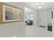 Bright foyer with neutral walls, tile flooring, and a decorative painting on the left at 4136 Shrewbury Pl, Land O Lakes, FL 34638