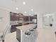 Bright kitchen with a large island with barstool seating, stainless steel appliances, and ample cabinet space at 4136 Shrewbury Pl, Land O Lakes, FL 34638