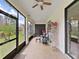 View of the home's screened in lanai with seating and decorations at 4136 Shrewbury Pl, Land O Lakes, FL 34638