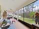 The screened lanai is furnished and has a calming view of the backyard with mature trees at 4136 Shrewbury Pl, Land O Lakes, FL 34638