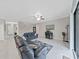 Spacious living room featuring neutral walls, tile flooring, and a cozy seating area at 4136 Shrewbury Pl, Land O Lakes, FL 34638