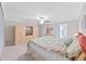 Serene main bedroom with large bed, soft carpet, en-suite bathroom, and built-in TV at 4136 Shrewbury Pl, Land O Lakes, FL 34638