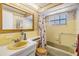 Bathroom featuring a tub with nautical-themed shower curtain, a window, and a vanity at 4215 Regal Pl, New Port Richey, FL 34652