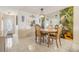 Open dining area with a light fixture, a large mirror, and tile flooring throughout at 4215 Regal Pl, New Port Richey, FL 34652