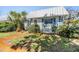 Quaint single-story home featuring lush landscaping, a verdant lawn, and a durable metal roof at 4215 Regal Pl, New Port Richey, FL 34652