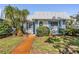 Charming single-story home with well-maintained landscaping, vibrant lawn and metal roof at 4215 Regal Pl, New Port Richey, FL 34652