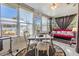 Enclosed patio space, featuring large windows, dining table, and seating area at 4215 Regal Pl, New Port Richey, FL 34652