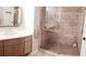 Beautiful bathroom with a gray vanity and oversized shower with stone tile and mosaic floor at 4270 Castlebridge Ln # 1722, Sarasota, FL 34238