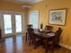 A dining room with wood floors, a decorative painting, and natural lighting at 429 Grant St, Dunedin, FL 34698