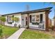 A welcoming porch with dark trim, flower-filled window boxes, and a cozy rocking chair for relaxing at 455 49Th N Ave, St Petersburg, FL 33703