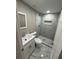Modern bathroom with a tiled walk-in shower and a sleek white vanity at 4731 Foothill Dr, Holiday, FL 34690