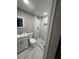 Bathroom boasts a new shower with marble tiling, a sink, and a toilet at 4731 Foothill Dr, Holiday, FL 34690
