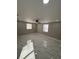 Bright bedroom with white marble-style tile flooring and a ceiling fan at 4731 Foothill Dr, Holiday, FL 34690