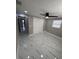 Bedroom with white marble-style tile flooring, ceiling fan, and closet at 4731 Foothill Dr, Holiday, FL 34690