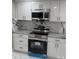 Well-appointed kitchen features granite countertops, stainless steel appliances at 4731 Foothill Dr, Holiday, FL 34690