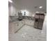 Modern kitchen features stainless steel appliances, marble backsplash and granite countertops at 4731 Foothill Dr, Holiday, FL 34690