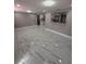 Open living room with elegant marble floors and pass-through to the kitchen at 4731 Foothill Dr, Holiday, FL 34690