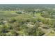 Picturesque aerial vista of homes situated in a verdant setting, highlighted by ponds and extensive green meadows at 4814 Knights Loop, Plant City, FL 33565