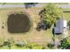 Aerial view of house lot with pond and old trees at 4814 Knights Loop, Plant City, FL 33565