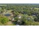 Stunning aerial view of a property surrounded by lush trees, a serene pond, and tranquil green pastures at 4814 Knights Loop, Plant City, FL 33565