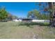 Expansive backyard featuring a well-maintained lawn and white fencing that creates a serene outdoor living space at 4814 Knights Loop, Plant City, FL 33565