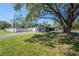 Spacious, shaded backyard featuring a well-maintained lawn and privacy fence at 4814 Knights Loop, Plant City, FL 33565