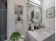 Stylish bathroom boasts a sleek white vanity, black accents, modern fixtures, and decorative wall art at 4814 Knights Loop, Plant City, FL 33565