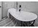 Elegant bathtub with sleek black exterior and modern fixtures set against a stylish, neutral rug at 4814 Knights Loop, Plant City, FL 33565