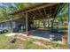 View of a spacious carport with a metal roof and concrete floor providing ample parking and storage at 4814 Knights Loop, Plant City, FL 33565