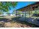 View of a spacious carport and backyard, providing ample parking and lawn at 4814 Knights Loop, Plant City, FL 33565