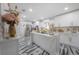 Bright kitchen featuring a large island, marble countertops, white cabinetry, and modern appliances at 4814 Knights Loop, Plant City, FL 33565