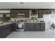 Modern kitchen with black cabinetry, stainless appliances, marble floor, and ample counter space at 4814 Knights Loop, Plant City, FL 33565